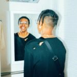 It's All About You. (Young man looks at himself in the mirror).