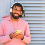 J Balvin Mixteip Album Review A Young Man Is Pictured Listening To Music.