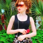 Bia Bianca Song By Song Album Review. Picture Of Young Lady Listening To Music.