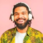 Chronixx Exile Album Review Rasta Man listening to music with headphones on.