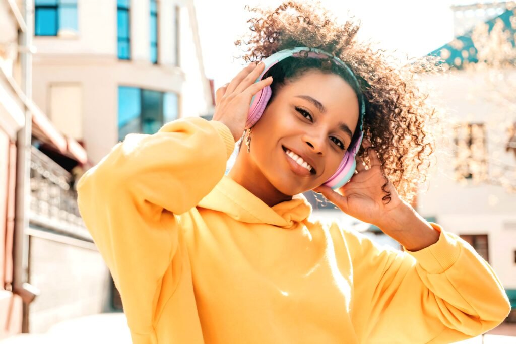 16 Brand New Soca Songs You Should Listen To - A Beautiful Young Woman listening to music.