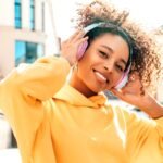 16 Brand New Soca Songs You Should Listen To - A Beautiful Young Woman listening to music.