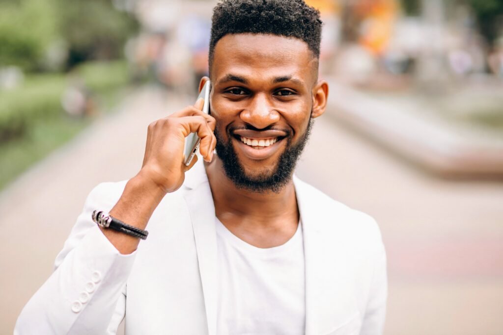 An Update On All Things Island Love WI - pictured is a young man on his phone.