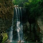 People Enjoying River And Waterfall In Jamaica.