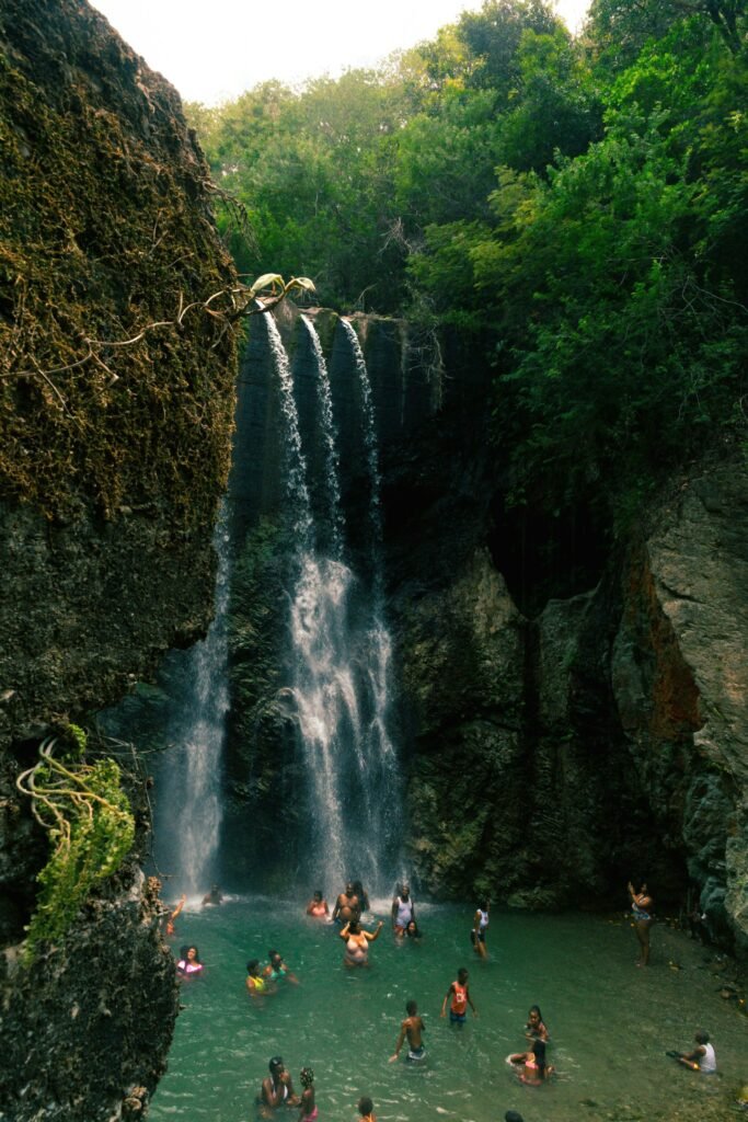 People Enjoying River And Waterfall In Jamaica.